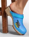 Pair of Clogs on Woman's Legs Sitting on Stool Mockup