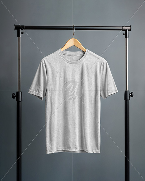 T-Shirt on a Wooden Hanger Against a Plain Background Mockup