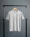 T-Shirt on a Wooden Hanger Against a Plain Background Mockup