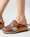 Pair of Clogs on Woman's Legs Sitting on Stool Mockup