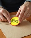 Round Sticker in a Hands Mockup
