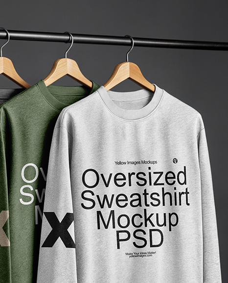 Three Sweatshirts on a Black Rack Against a Plain Background Mockup
