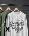 Three Sweatshirts on a Black Rack Against a Plain Background Mockup