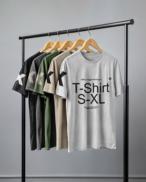Five T-Shirts on a Wooden Hanger Against a Plain Background Mockup - T-shirt mockup