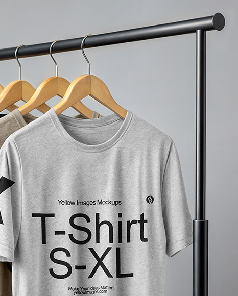 Five T-Shirts on a Wooden Hanger Against a Plain Background Mockup