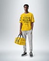 Man Wearing T-Shirt and Sweatpants Holding Duffle Bag Mockup