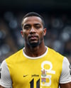Soccer Player Wearing a Crew Neck Jersey and Shorts at the Stadium Mockup