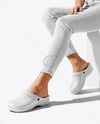 Pair of Clogs on Woman's Legs Sitting on Block Mockup
