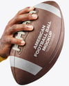 American Football Ball in a Hand Mockup