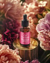 Amber Dropper Bottle with Oil Tincture Surrounded by Flowers Mockup