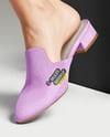Pair of Suede Mules on Woman's Legs with Skirt Mockup