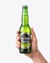 Green Glass Beer Bottle in a Hand Mockup