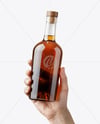 Whisky Bottle in a Hand Mockup