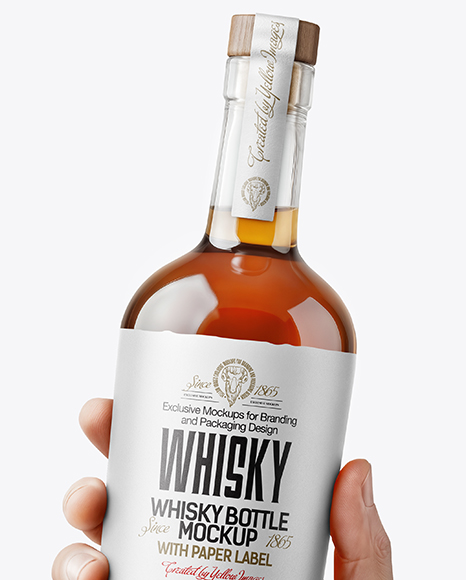 Whisky Bottle in a Hand Mockup