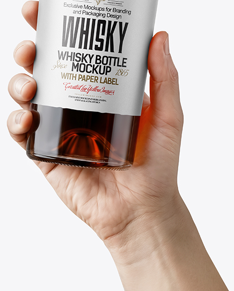 Whisky Bottle in a Hand Mockup