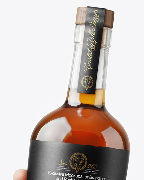 Whisky Bottle in a Hand Mockup