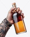 Whisky Bottle in a Hand Mockup