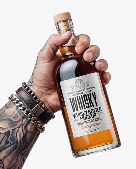 Whisky Bottle in a Hand Mockup