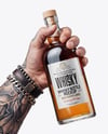 Whisky Bottle in a Hand Mockup