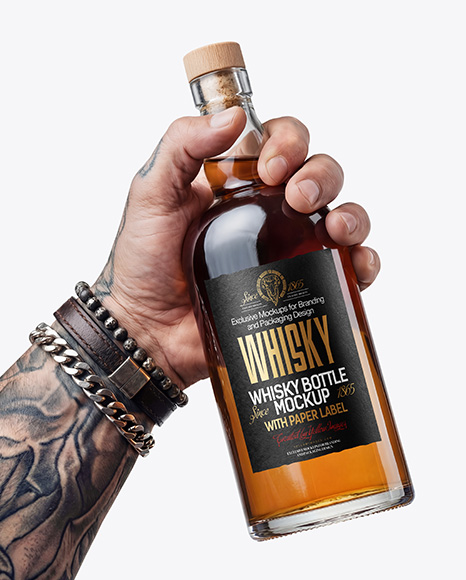 Whisky Bottle in a Hand Mockup