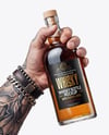 Whisky Bottle in a Hand Mockup