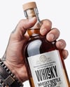Whisky Bottle in a Hand Mockup