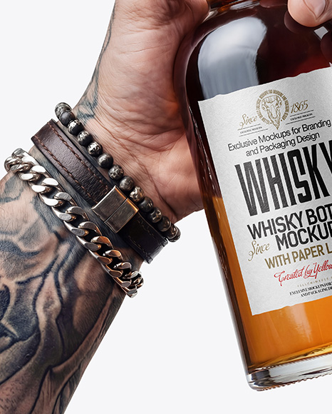 Whisky Bottle in a Hand Mockup