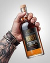 Whisky Bottle in a Hand Mockup