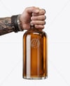 Whisky Bottle in a Hand Mockup