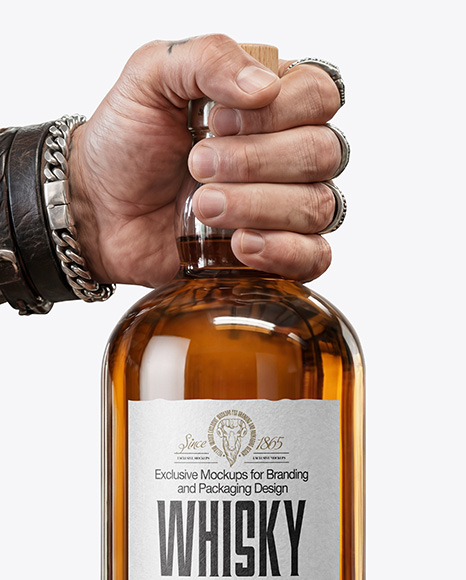Whisky Bottle in a Hand Mockup