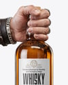 Whisky Bottle in a Hand Mockup