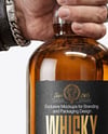 Whisky Bottle in a Hand Mockup