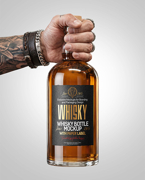 Whisky Bottle in a Hand Mockup