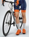 Woman Wearing Full Cycling Kit with Road Bike Mockup